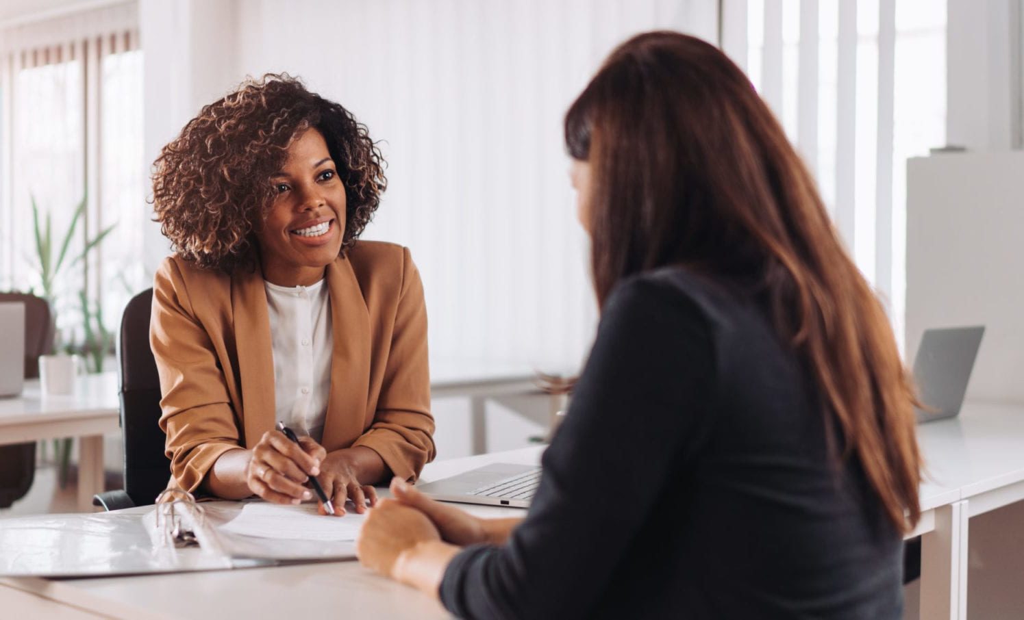 Woman consulting with a female financial manager at the bank